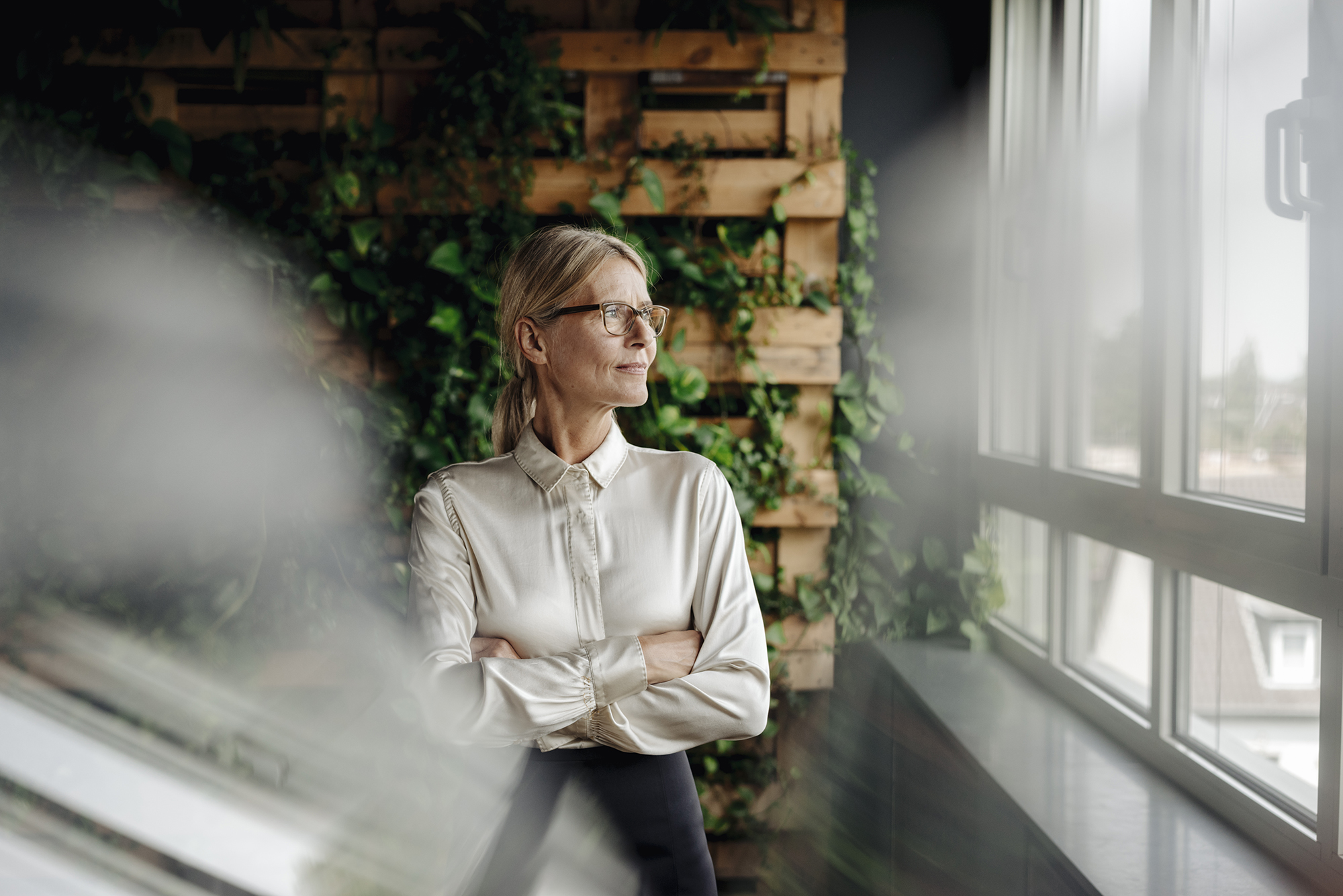 Lawyer looking out window of green office
